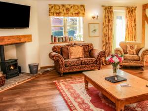 a living room with couches and a coffee table at The Milking Parlour in Craven Arms