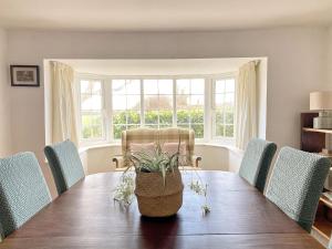 a dining room with a wooden table and chairs at Grange Farm Cottage in Sleaford