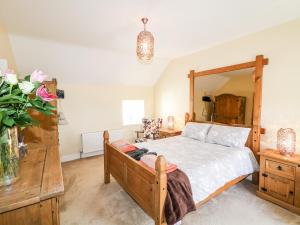 A bed or beds in a room at Whispering Willows - The Thatch