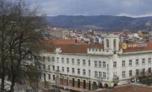 un grand bâtiment blanc avec une ville en arrière-plan dans l'établissement Даунтаун Велико Търново, à Veliko Tarnovo