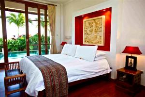 a bedroom with a bed and a window with a pool at Villa Padi in Canggu +55 photos