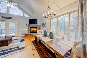 a dining room with a table and a fireplace at Fairway Getaway in Helen