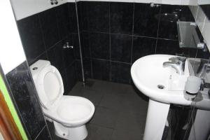 a bathroom with a white toilet and a sink at Bezel Bungalow Nuwara Eliya in Nuwara Eliya +56 photos
