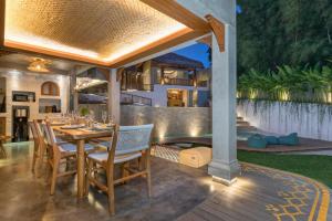 an outdoor dining area with a table and chairs at Arkana Village Canggu by Nagisa Bali in Canggu