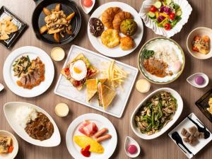 a table full of plates of food on a table at Shin Yokohama Prince Hotel in Yokohama