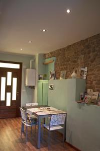 a kitchen with a table and chairs in a room at Di-vinodormire in La Morra