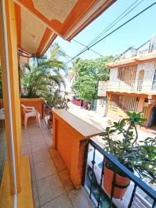 a balcony with a table and a view of a street at Casa de Huespedes Cielito Lindo in Santa Cruz Huatulco