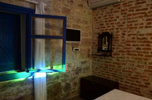 a room with a window with a blue light at Cunda Mavi Hotel in Ayvalık