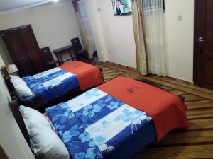 Postel nebo postele na pokoji v ubytování HOTEL VELANEZ SUITE Riobamba