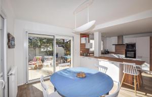 una cucina e una sala da pranzo con tavolo blu di Holiday Home Canet Plage Bld De La Loge Sur Mer a Canet-en-Roussillon