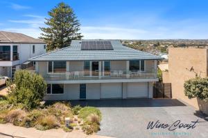 a house with solar panels on the roof at 35 Degrees South by Wine Coast Holiday Rentals - Escape to the fabulous 35 Degrees South by Wine Coast Holiday Rentals. in Port Noarlunga