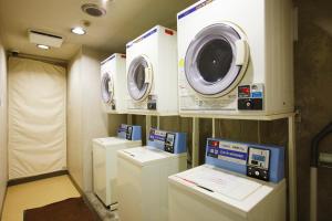 a room with three washing machines and a washer and dryer at Sankei City Hotel Chiba in Chiba