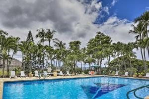 a pool at a resort with palm trees at Lush Condo with Community Pool, 1 Mi to Beach! in Waianae
