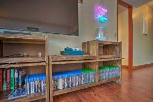 a room with wooden book shelves filled with books at Lush Condo with Community Pool, 1 Mi to Beach! in Waianae