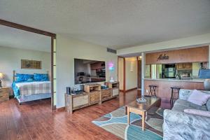 a living room with a couch and a bed at Lush Condo with Community Pool, 1 Mi to Beach! in Waianae