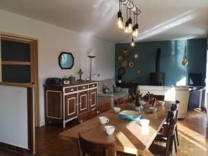 a dining room with a large wooden table and chairs at Stylish Holiday Home in Morlaix with Private Garden in Saint-Martin-des-Champs