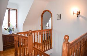 a wooden staircase in a house with a mirror at 4 Bedroom Amazing Home In Pleubian in Pleubian