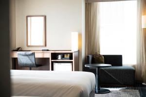 Postel nebo postele na pokoji v ubytování KOKO HOTEL Ginza-1chome