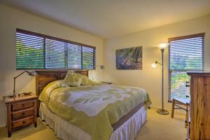 a bedroom with a bed and a lamp and windows at Kona Highlands Family Getaway 10-15 Min to Town! in Kailua-Kona