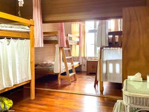 a room with two bunk beds and a window at Emix Ishigaki in Ishigaki Island