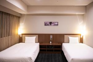 Postel nebo postele na pokoji v ubytování KOKO HOTEL Ginza-1chome
