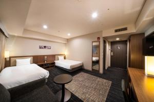 Postel nebo postele na pokoji v ubytování KOKO HOTEL Ginza-1chome