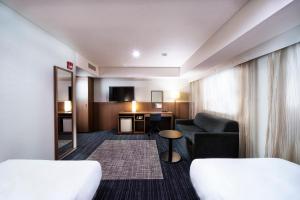 Postel nebo postele na pokoji v ubytování KOKO HOTEL Ginza-1chome