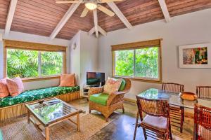 a living room with a couch and a table at Melemele Kapaa Cottage 1 Block to Beach! in Kapaa