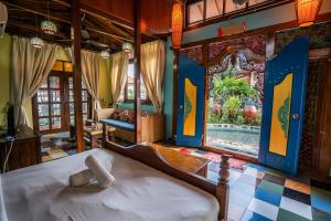 a bedroom with a bed and a view of a pool at Lost Paradise Resort in Batu Ferringhi