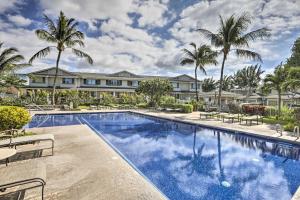 a swimming pool with palm trees and houses at Hawaiian Hideaway Pool Access, 1 Mi to Beach in Kapolei