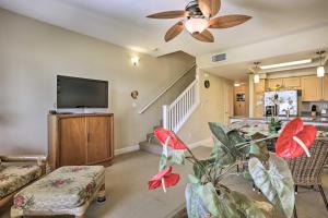 a living room with a ceiling fan and a flat screen tv at Hawaiian Hideaway Pool Access, 1 Mi to Beach in Kapolei