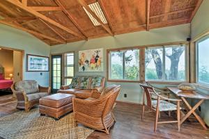 a living room with furniture and a table at View House in Laupahoehoe with Patio and Ocean Views! in Papaaloa +16 photos