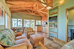 a living room with a couch and a table at View House in Laupahoehoe with Patio and Ocean Views! in Papaaloa