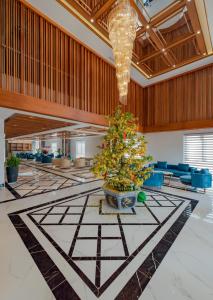 a christmas tree in the middle of a lobby at The Tahiti Beach Hotel in Phu Quoc
