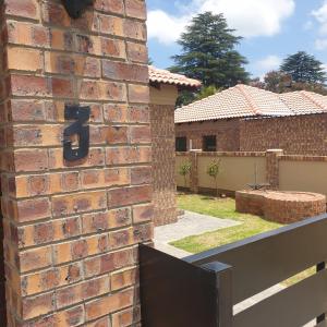 a brick wall with a number seven on it at @Lloyds in Ermelo