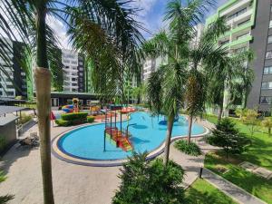 a large swimming pool with a playground in a city at Manhattan Condo Ipoh with Water Park and Pool View in Ipoh