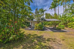 a garden with a house with a gazebo at Cozy Pahoa Hideaway Near Black-Sand Beaches! in Pahoa