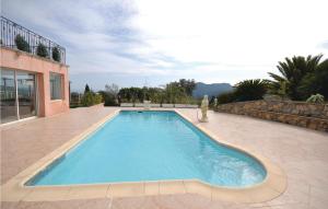 a large swimming pool with a person standing next to a building at Beautiful Home In Les Adrets With 5 Bedrooms, Wifi And Private Swimming Pool in Fréjus