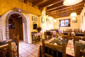 a restaurant with a dining room with tables and chairs at El Bouquet in Pla de l'Ermita