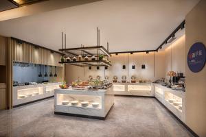 a large kitchen with a counter in the middle at Holiday Inn Express Beijing Yizhuang Center, an IHG Hotel in Beijing