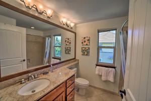 a bathroom with a sink and a toilet and a mirror at Waimea Condo Less Than 1 Mile from Mauna Lani Beach Club! in Waikoloa +23 photos