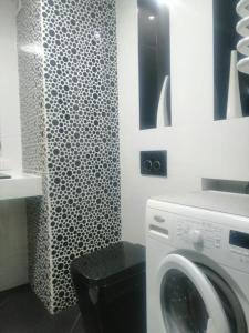 a bathroom with a washing machine and a shower at Apartament 35 in Olsztynek