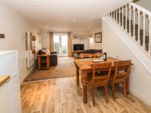 a kitchen and living room with a table and chairs at The Mistal in Keighley