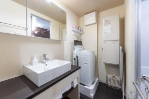 a bathroom with a sink and a refrigerator at VACATION INN HEIWAJIMA 1 - Vacation STAY 10876 in Tokyo