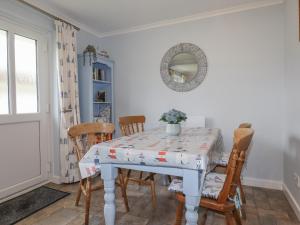 a dining room with a table and chairs at Merryfield Lodge in Liskeard