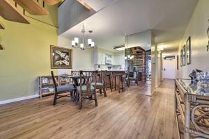 a dining room and living room with a table and chairs at Ocean View Kihei Retreat with Resort Amenities! in Wailea