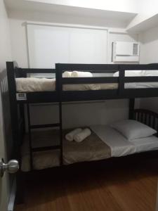 two bunk beds in a small room with a door at Adel's Haven in Camella Northpoint in Davao City