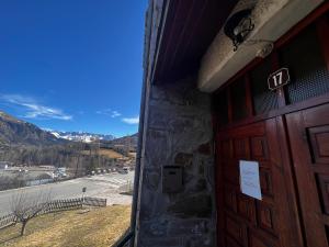 a door to a building with a view of the mountains at Balaitus ❆ Atico de 120m2 con garaje ✿❀✿ in Sallent de Gállego