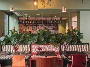 a restaurant with tables and plants on the wall at La Belle Ville in Paris +83 photos