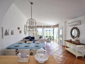 a dining room and living room with a table at Case Li Conchi Sardegna in Castiadas